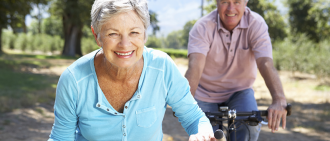 elderly couple biking